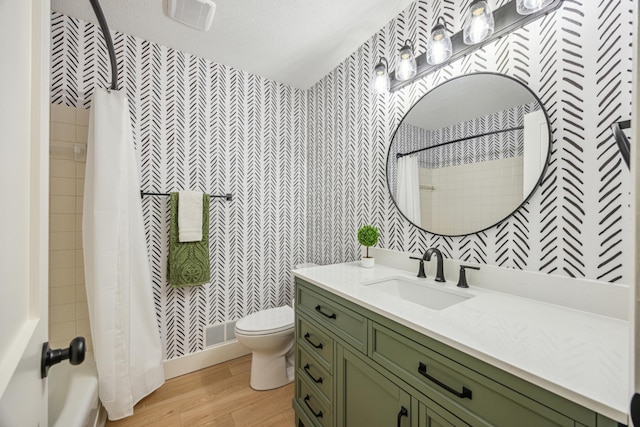 1588 Chatham Ave, Arden Hills, MN 55112 - full bathroom with wallpapered walls, wood finished floors, toilet, and vanity