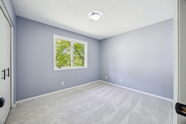 1588 Chatham Ave, Arden Hills, MN 55112 - unfurnished bedroom with carpet floors, a closet, a textured ceiling, and baseboards