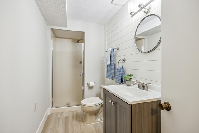 1588 Chatham Ave, Arden Hills, MN 55112 - full bathroom featuring a textured ceiling, a stall shower, wood finished floors, toilet, and vanity