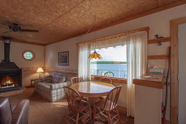 7528 Little Thunder Dr NE, Remer, MN 56672 - carpeted dining area featuring ceiling fan and a wood stove