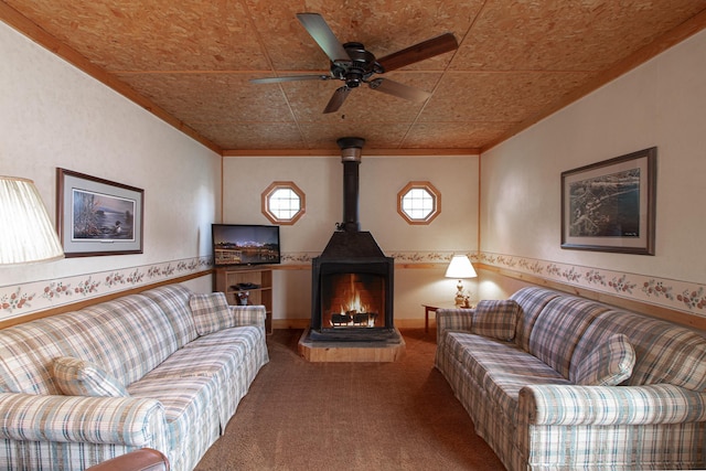 7528 Little Thunder Dr NE, Remer, MN 56672 - carpeted living area featuring a wood stove, an ornate ceiling, a ceiling fan, and crown molding