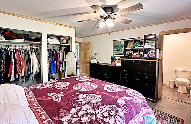 36974 320th St, Aitkin, MN 56431 - bedroom with two closets, wood finished floors, connected bathroom, ceiling fan, and ornamental molding