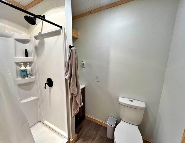 36974 320th St, Aitkin, MN 56431 - full bathroom featuring wood finished floors, a stall shower, and toilet