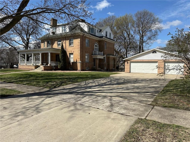 215 5th St S, Montevideo, MN 56265 - view of front of house featuring a chimney, a porch, driveway, brick siding, and a front lawn