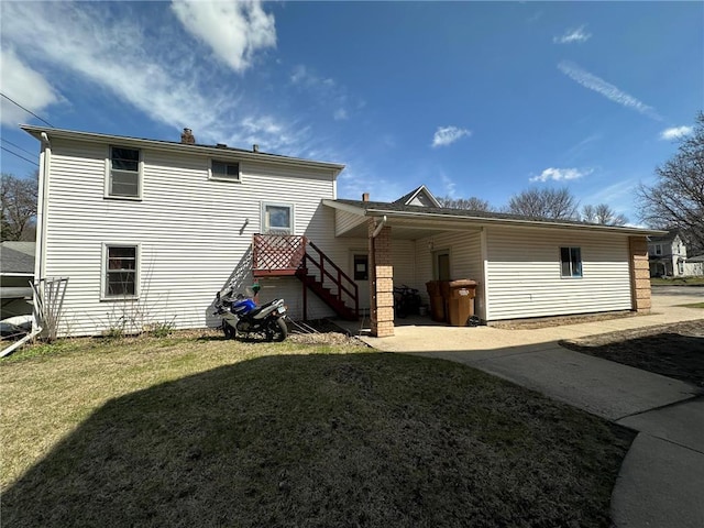 215 5th St S, Montevideo, MN 56265 - back of house featuring a yard and a chimney