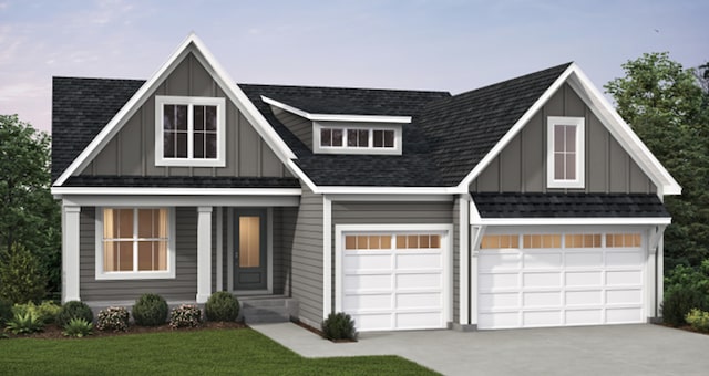 view of front facade featuring concrete driveway, board and batten siding, a front lawn, and a garage