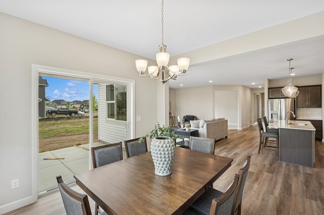 1419 Victory Ln NE, Isanti, MN 55040 - dining room with light wood-style flooring, baseboards, a chandelier, and recessed lighting