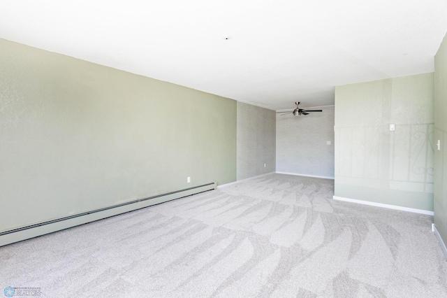 carpeted empty room featuring baseboard heating, ceiling fan, and baseboards