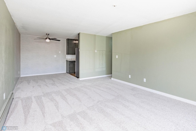 unfurnished living room with a baseboard radiator, carpet, ceiling fan, and baseboards
