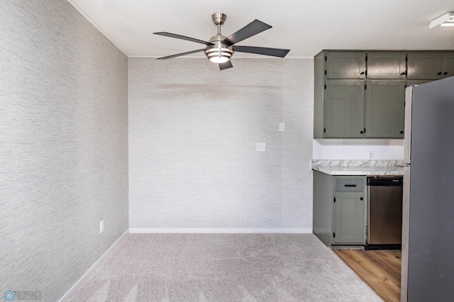kitchen with appliances with stainless steel finishes, a ceiling fan, baseboards, light countertops, and gray cabinets