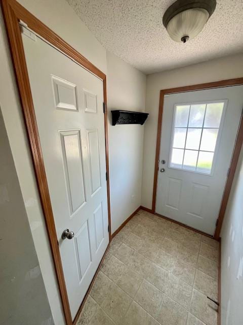 4947 Emmit Dr N Unit 4, Hugo, MN 55038 - entryway featuring a textured ceiling, light tile patterned floors, and baseboards