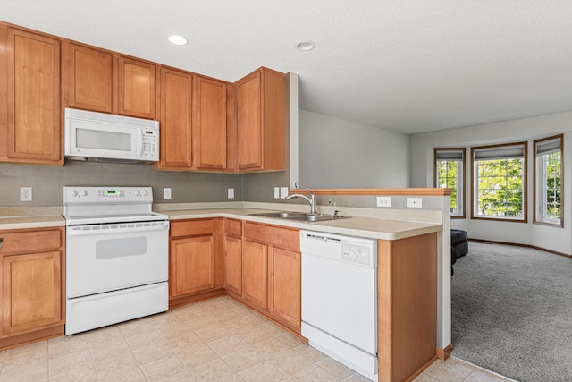 4947 Emmit Dr N Unit 4, Hugo, MN 55038 - kitchen with white appliances, a sink, a peninsula, light countertops, and recessed lighting