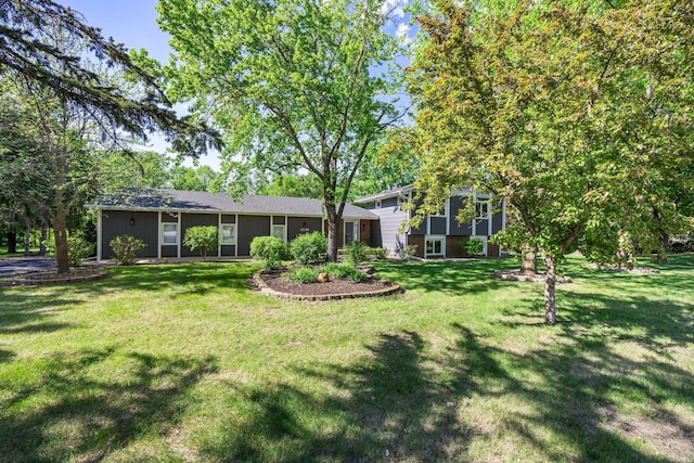 back of house with a lawn