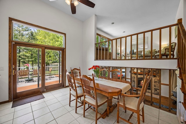 dining area with a ceiling fan and light tile patterned flooring