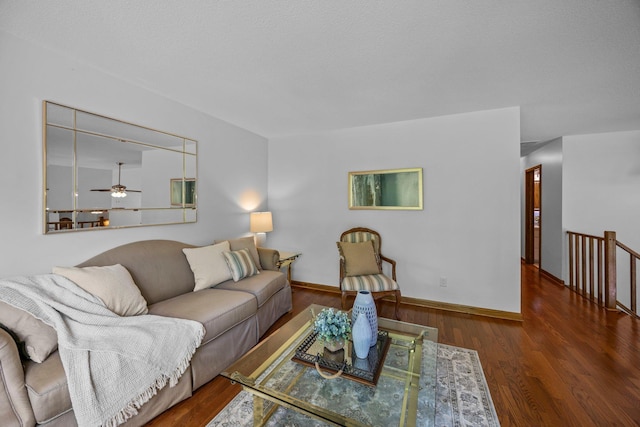 living area featuring a ceiling fan, wood finished floors, and baseboards