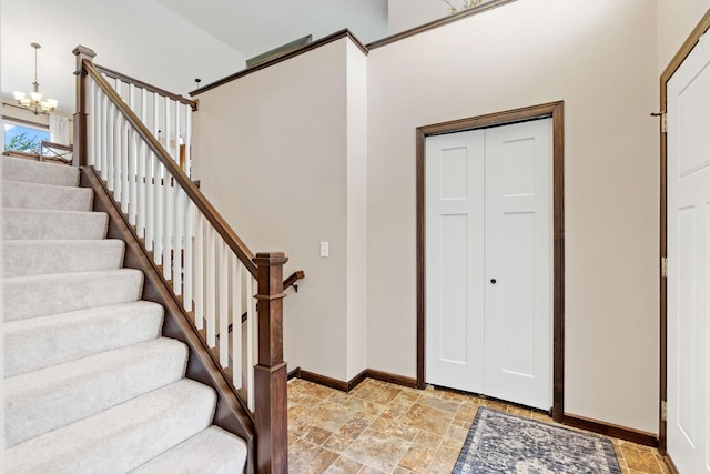 805 Cologne Ln, Waverly, MN 55390 - foyer entrance with light stone finish flooring, baseboards, stairway, and a chandelier