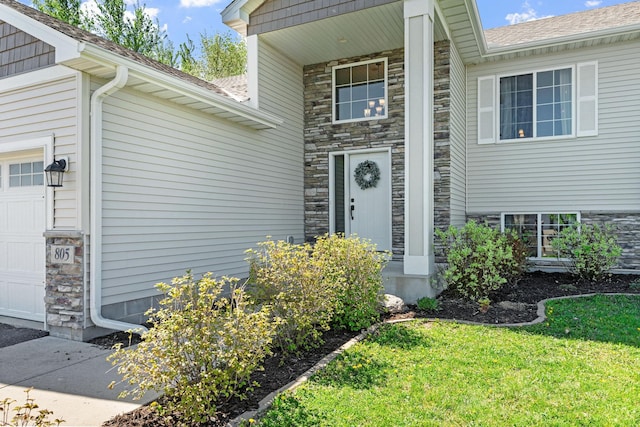 805 Cologne Ln, Waverly, MN 55390 - property entrance featuring a lawn, stone siding, and an attached garage