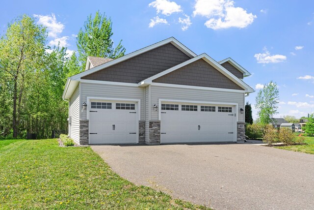 805 Cologne Ln, Waverly, MN 55390 - view of front of home featuring stone siding, a front lawn, an attached garage, and asphalt driveway