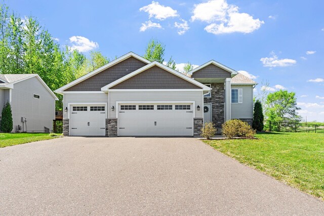 805 Cologne Ln, Waverly, MN 55390 - craftsman house featuring stone siding, asphalt driveway, and a garage