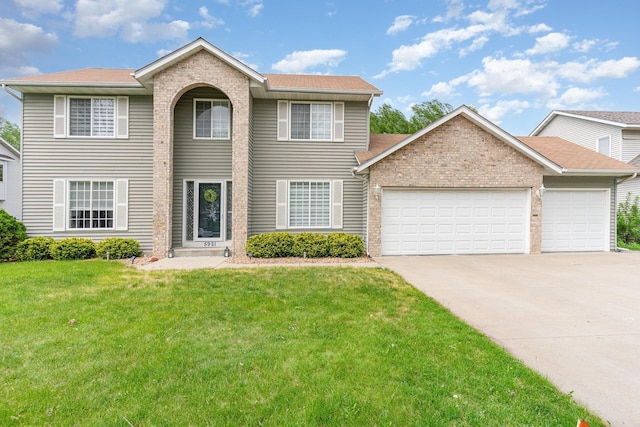 5921 200th St W, Farmington, MN 55024 - colonial inspired home with an attached garage, concrete driveway, a front yard, and brick siding