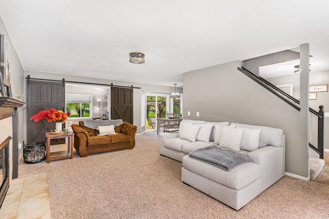 5921 200th St W, Farmington, MN 55024 - carpeted living room featuring a barn door, a chandelier, a textured ceiling, and a tile fireplace