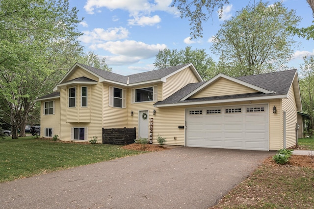 1002 8th Ave N, Princeton, MN 55371 - view of front facade featuring driveway, a shingled roof, a garage, and a front yard