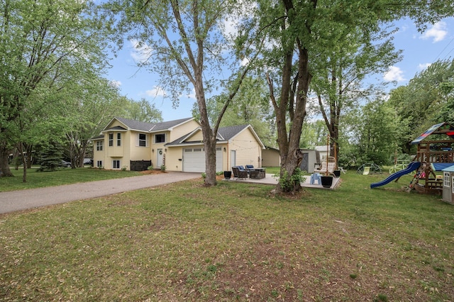 1002 8th Ave N, Princeton, MN 55371 - view of front of property featuring asphalt driveway, a garage, a playground, and a front yard