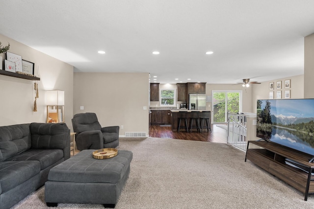 1002 8th Ave N, Princeton, MN 55371 - living area with dark colored carpet, recessed lighting, a ceiling fan, and baseboards