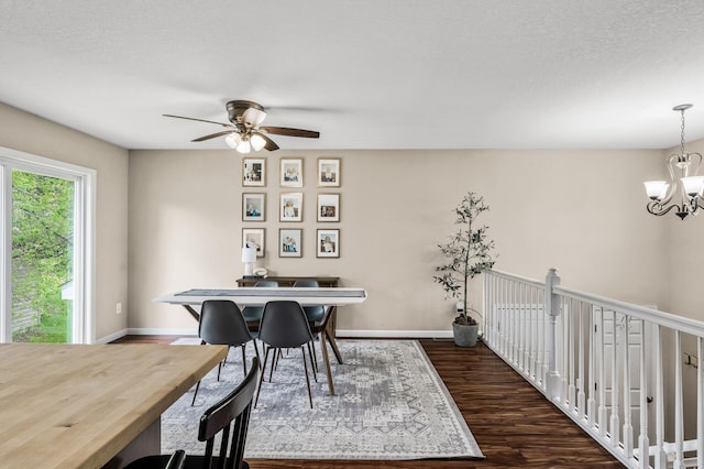 1002 8th Ave N, Princeton, MN 55371 - dining area with a chandelier, dark wood finished floors, ceiling fan, baseboards, and a textured ceiling