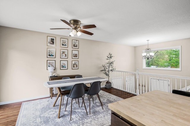 1002 8th Ave N, Princeton, MN 55371 - dining room featuring dark wood-style floors, ceiling fan, a chandelier, and baseboards