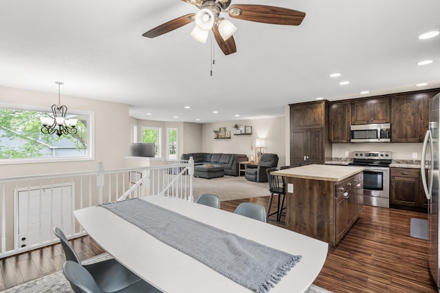 1002 8th Ave N, Princeton, MN 55371 - kitchen with appliances with stainless steel finishes, dark wood-style floors, dark brown cabinets, a center island, and recessed lighting