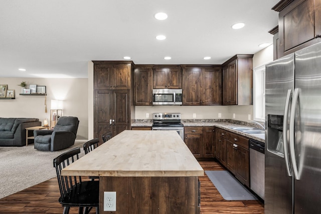 1002 8th Ave N, Princeton, MN 55371 - kitchen featuring appliances with stainless steel finishes, open floor plan, a sink, dark brown cabinets, and recessed lighting