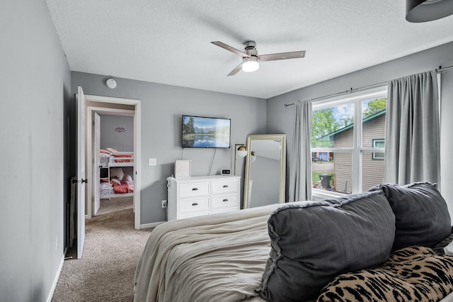 1002 8th Ave N, Princeton, MN 55371 - carpeted bedroom featuring a textured ceiling, a ceiling fan, and baseboards