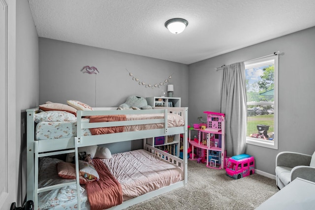1002 8th Ave N, Princeton, MN 55371 - carpeted bedroom with a textured ceiling and baseboards