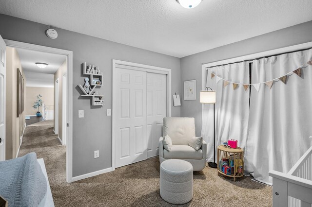 1002 8th Ave N, Princeton, MN 55371 - sitting room with carpet, a textured ceiling, and baseboards