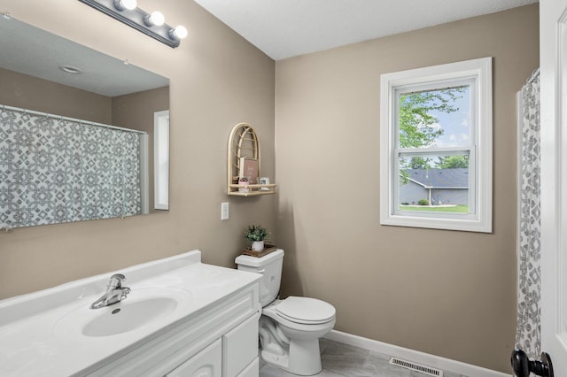 1002 8th Ave N, Princeton, MN 55371 - full bathroom featuring vanity, toilet, and baseboards