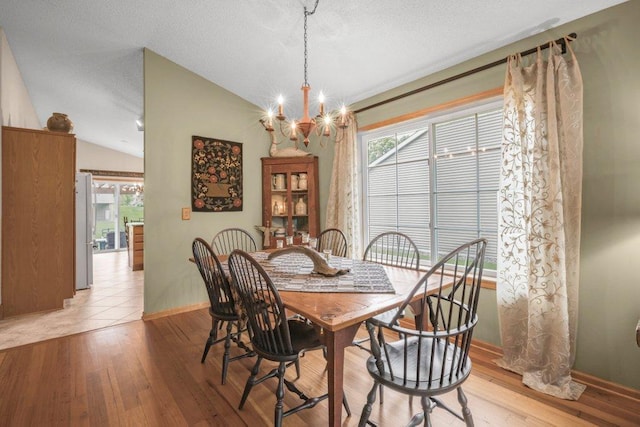 11419 17th St NE, Saint Michael, MN 55376 - dining space with a chandelier, baseboards, light wood finished floors, and vaulted ceiling