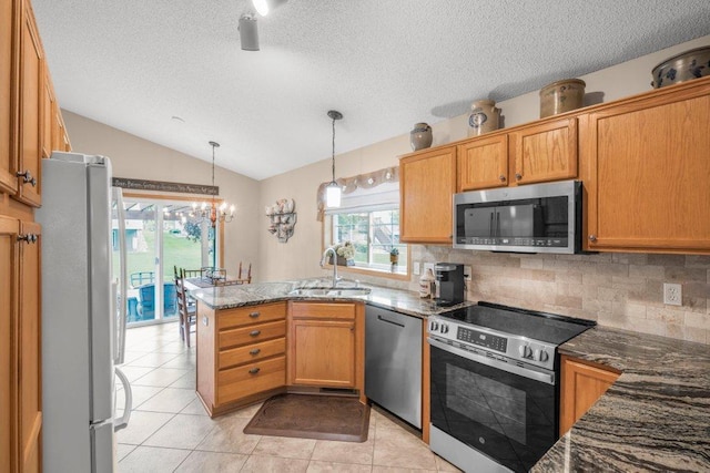 11419 17th St NE, Saint Michael, MN 55376 - kitchen featuring appliances with stainless steel finishes, a sink, a peninsula, lofted ceiling, and a textured ceiling