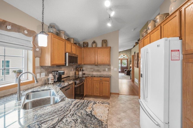 11419 17th St NE, Saint Michael, MN 55376 - kitchen with appliances with stainless steel finishes, a sink, vaulted ceiling, light stone counters, and tasteful backsplash