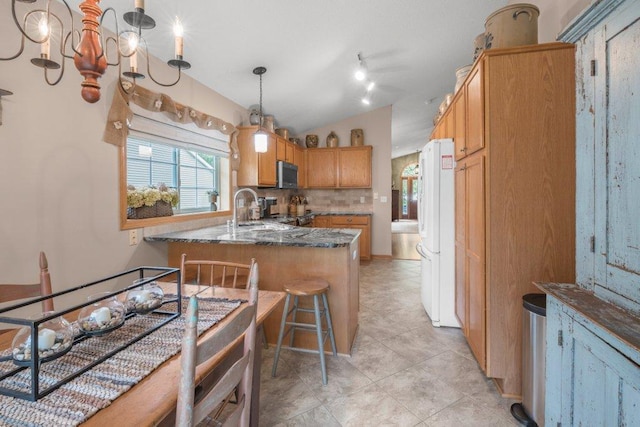 11419 17th St NE, Saint Michael, MN 55376 - kitchen with stainless steel microwave, a sink, freestanding refrigerator, vaulted ceiling, and a peninsula