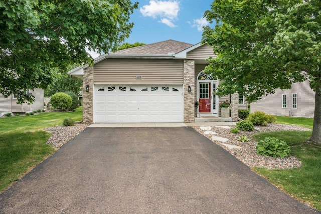 11419 17th St NE, Saint Michael, MN 55376 - view of front of home with asphalt driveway, a front lawn, a garage, brick siding, and roof with shingles