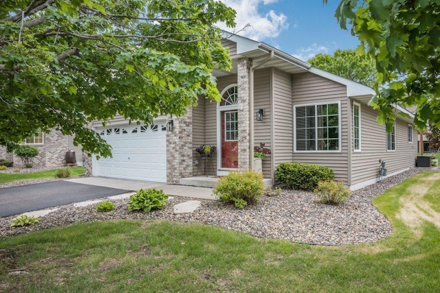 11419 17th St NE, Saint Michael, MN 55376 - view of front of property with a garage, asphalt driveway, cooling unit, and a front lawn