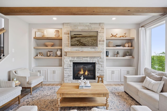 living area featuring beamed ceiling, light wood-style floors, a fireplace, and recessed lighting
