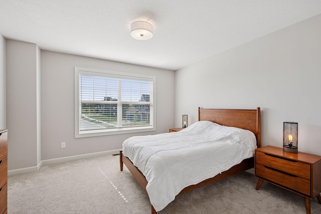 bedroom featuring carpet and baseboards