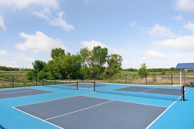 view of tennis court featuring fence and community basketball court