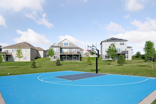 view of basketball court featuring community basketball court, a yard, and a residential view