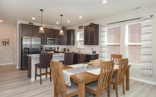 304 Rum River Way, Anoka, MN 55303 - dining area with light wood-style floors, baseboards, and recessed lighting