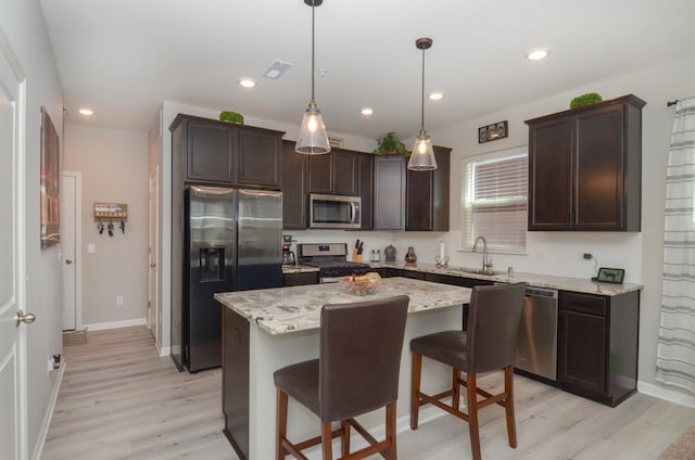 304 Rum River Way, Anoka, MN 55303 - kitchen featuring stainless steel appliances, dark brown cabinetry, light wood-type flooring, a center island, and recessed lighting