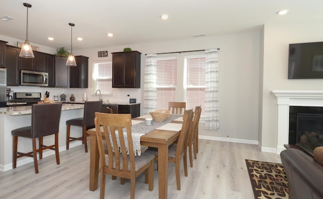 304 Rum River Way, Anoka, MN 55303 - dining room featuring light wood-style flooring, baseboards, and recessed lighting