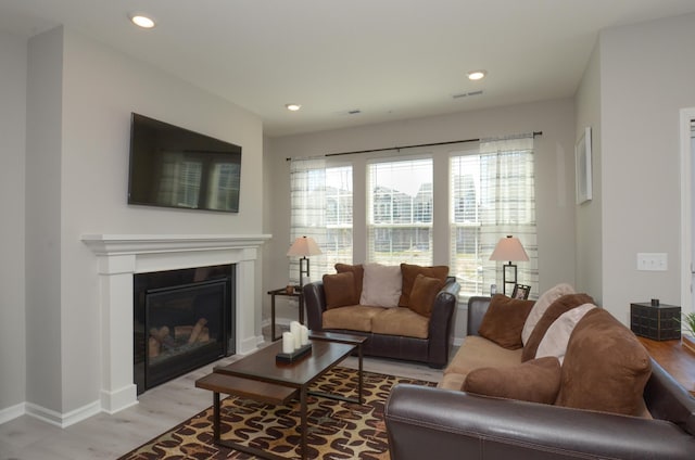304 Rum River Way, Anoka, MN 55303 - living room with light wood finished floors, a glass covered fireplace, recessed lighting, and baseboards